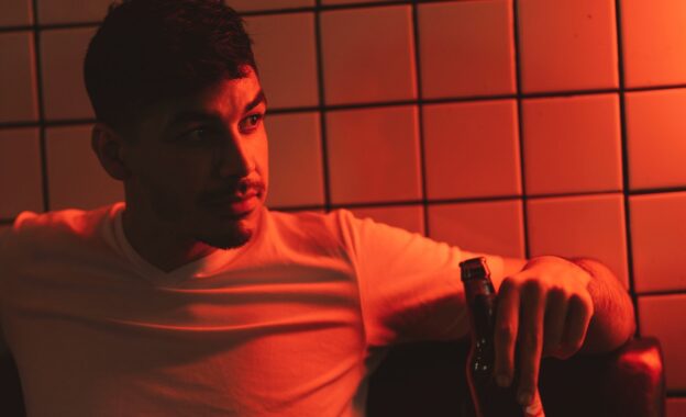 a young man drinking beer