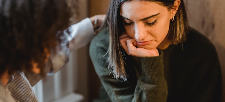 a woman worried about Alcohol abuse among young adults in WV patting a girl on the shoulder