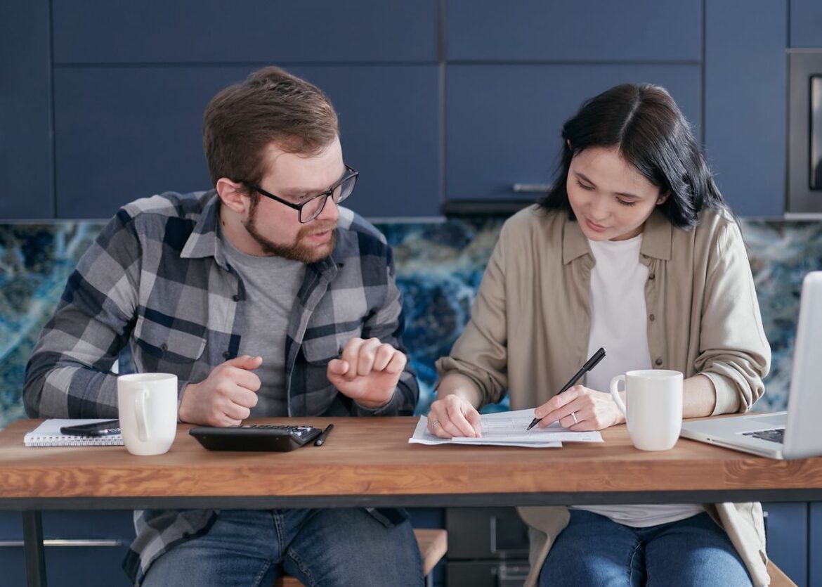 Couple reviewing household bills and expenses, illustrating the financial burden of addiction on families.