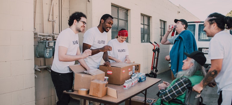volunteers helping an older man