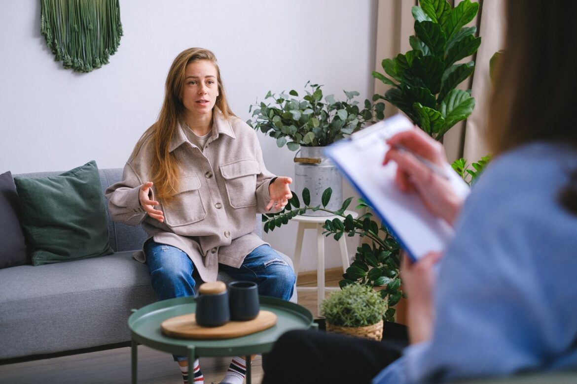Therapist speaking with a client during a mental health counseling session.