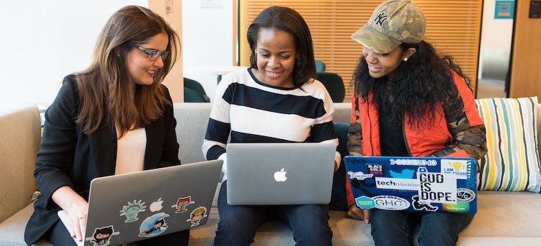 College students watching something on their laptops.