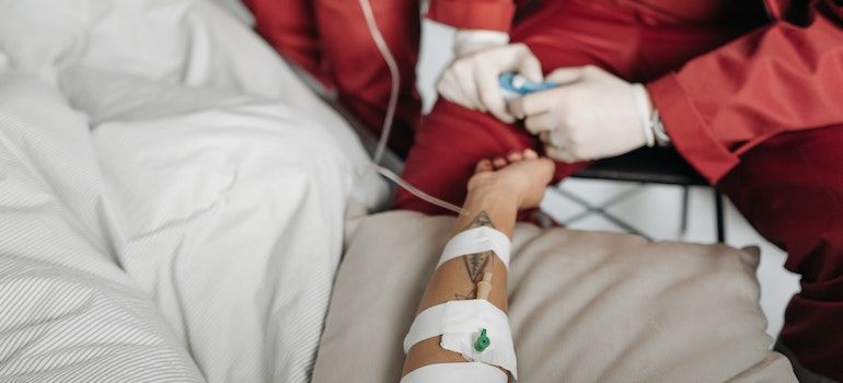 Person being taken care of by ambulance doctors