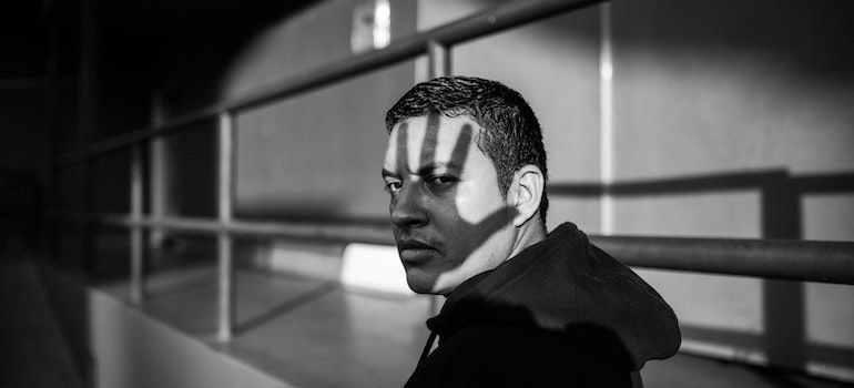 Person with the shadow of a hand on their face.
