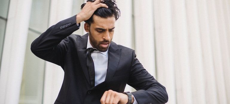 Person realizing they will be late for work representing the signs of a high-functioning addict