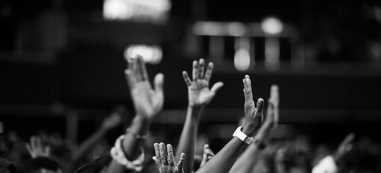 Raised hands of multiple people