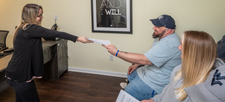 A group of people holding hands during a group therapy session.