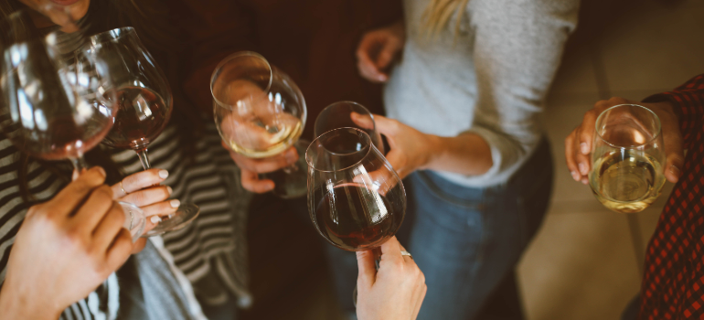 A group of women with glasses of wine in their hands.