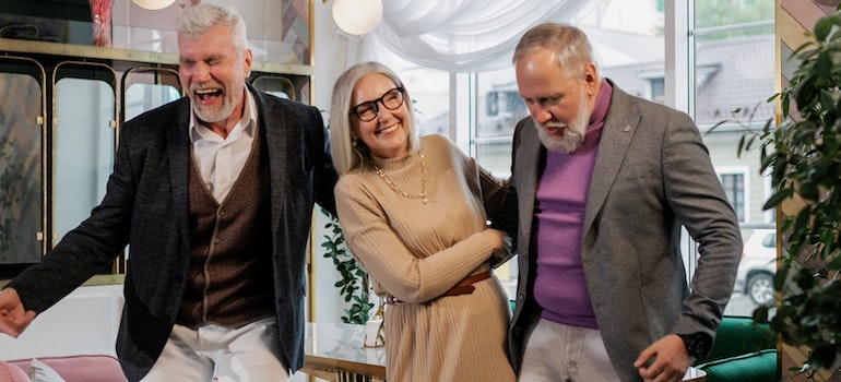 A group of diverse elderly individuals laughing and sharing a light moment.