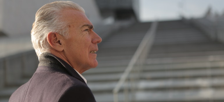 An older man's face standing outside looking at the distance representing the Alcohol addiction impact on older adults in West Virginia