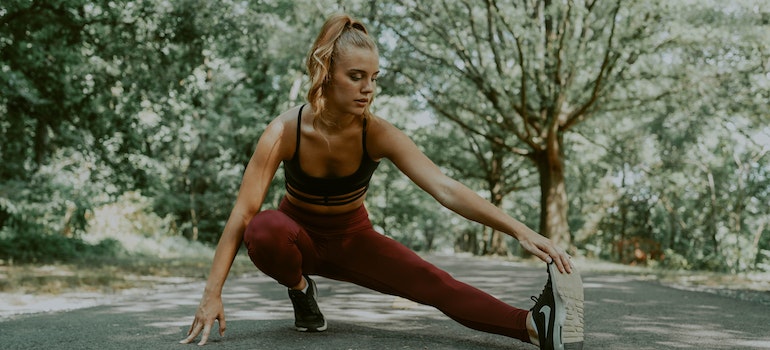 A person preparing to exercise, aware of the connection between physical health and recovery capital