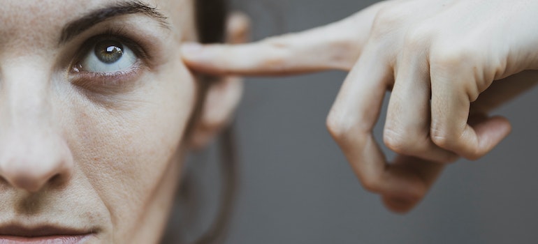 A person pointing to their head