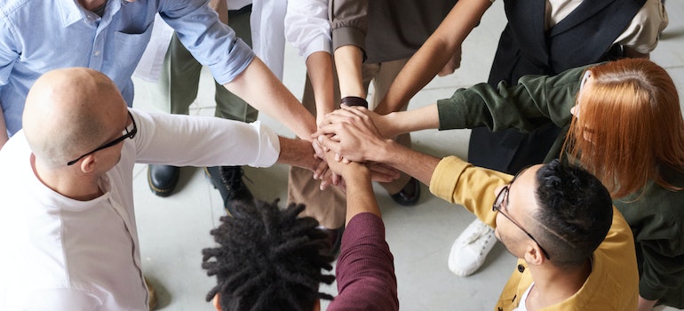A group of people putting hands together