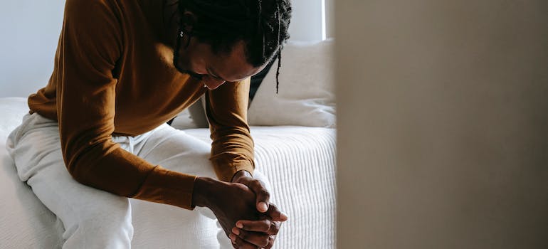 A person addicted to gas station heroin sitting alone, coping with depression