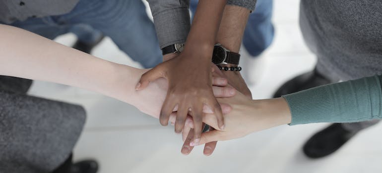 A group of people putting their hands together