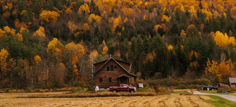 A rural house, a field in front of it and a forest behind it in a rural area of West Virginia