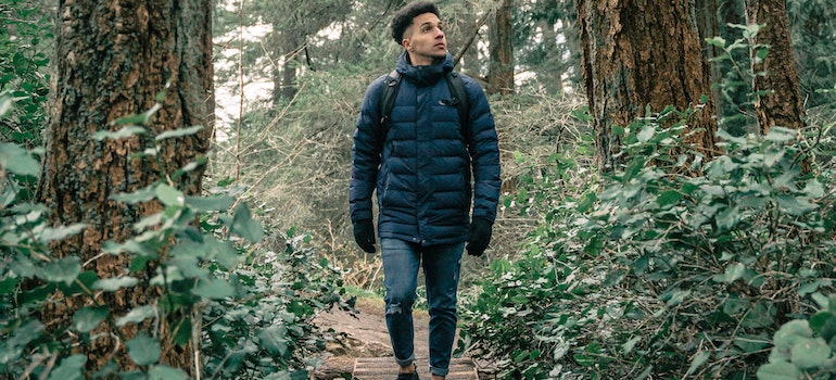 A person walking in nature, participating in nature-based therapies in West Virginia