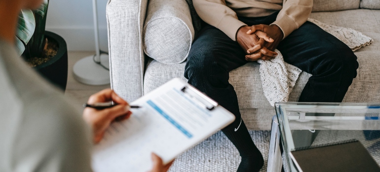 A therapist writing on a paper
