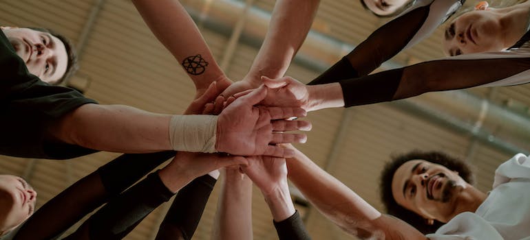 A group of people joining hands together during the program promoting aftercare in Huntington WV