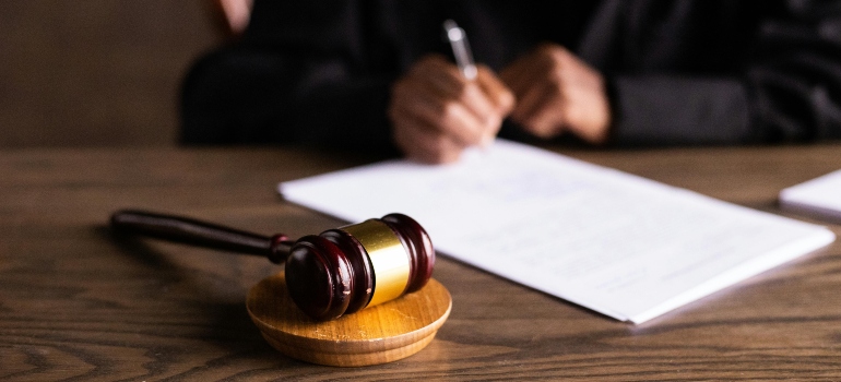 A judge signing documents on how parental substance abuse affects children in Athens OH