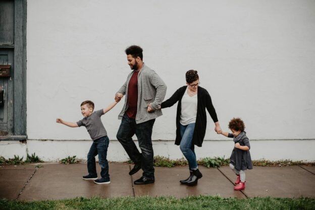 Parents and their children walking together while holding hands