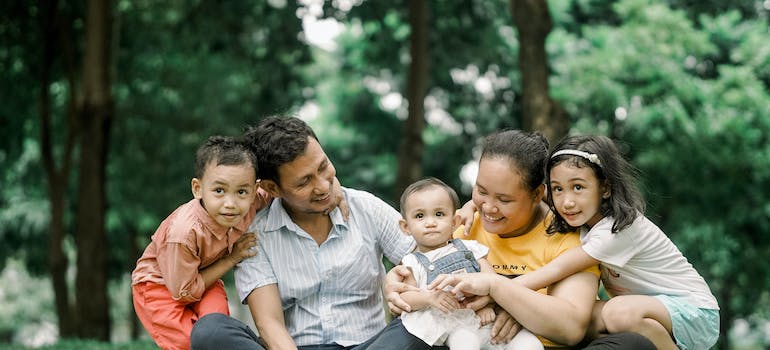 A family in the park, bonding, which is one of the Healthy Coping Mechanisms During Addiction Recovery in Fairmont WV