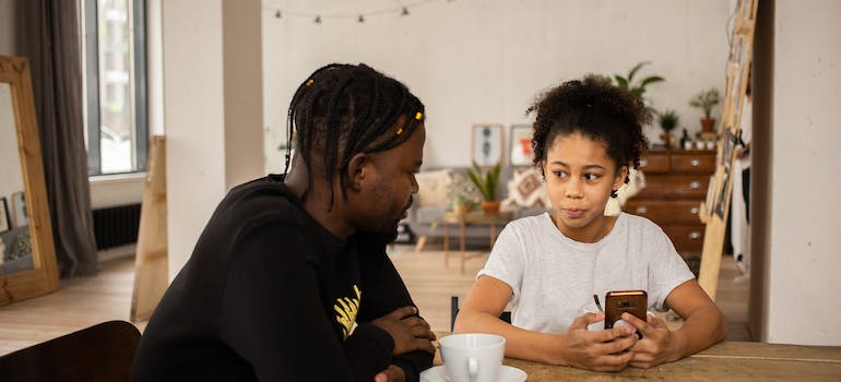 A father talking openly to his daughter, which is important as there is a strong relationship between substance abuse and parenting styles