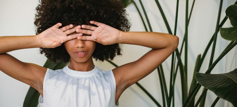A person covering their eyes with hands