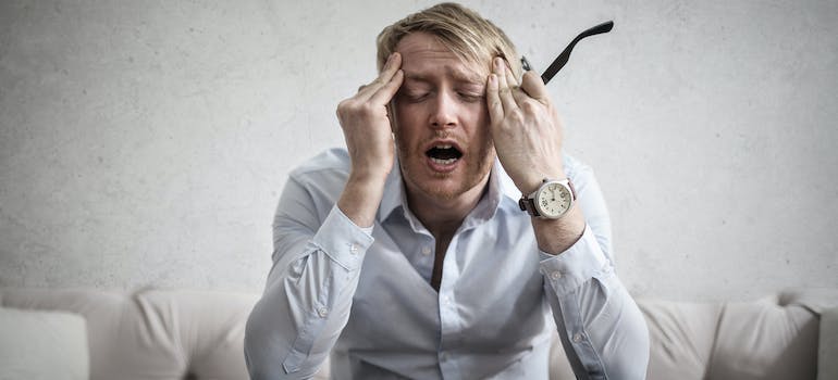 Photo Of Man Touching His Head. Long-term heavy drinkers are a significant group of people who are at a higher risk of developing Wet Brain Syndrome.