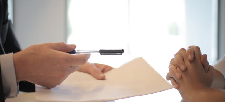 woman receiving a contract regarding her rehab service coverage