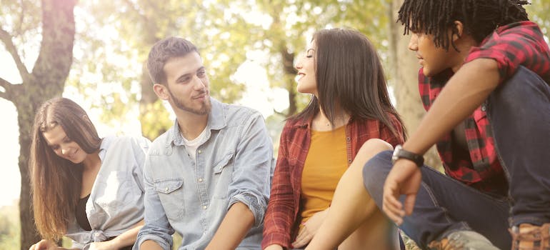 Young people sitting in the park, happy after having overcome their Ritalin addiction