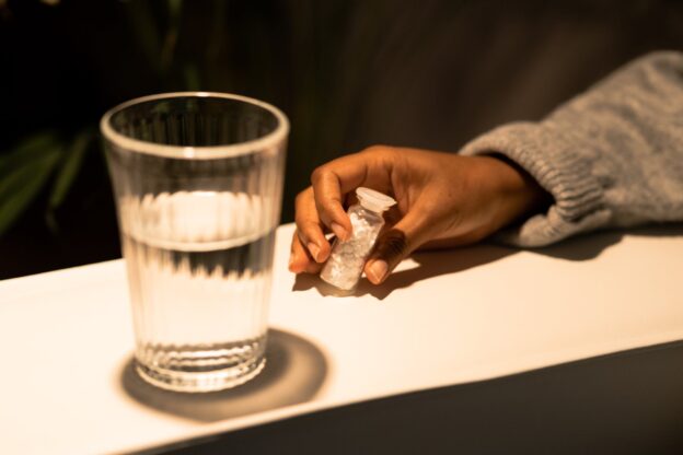 A person taking pills to cope with adjustment disorder