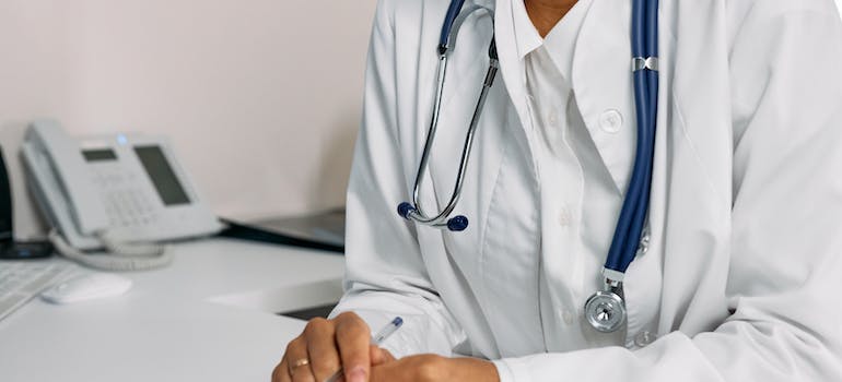 A doctors with a stethoscope thinking about Nitazenes Abuse in WV