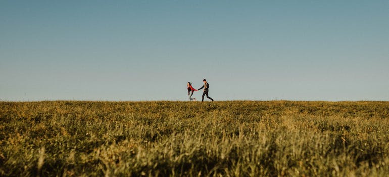 Two people running in the field freely after combating the dangers and rise of nitazenes abuse in WV