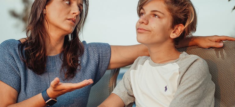 A parent and teenager talking about rehab centers
