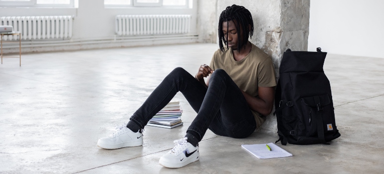 A man sitting alone on the floor
