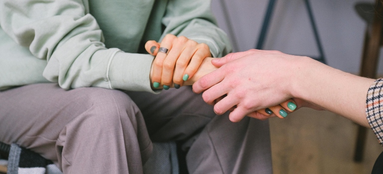 Two women holding hands