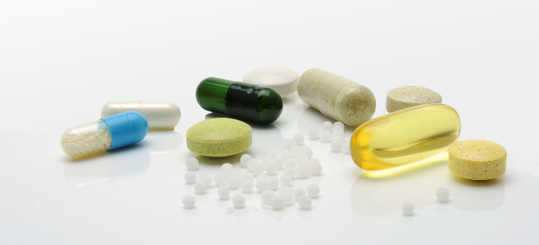 Many colorful drugs resting on a table.