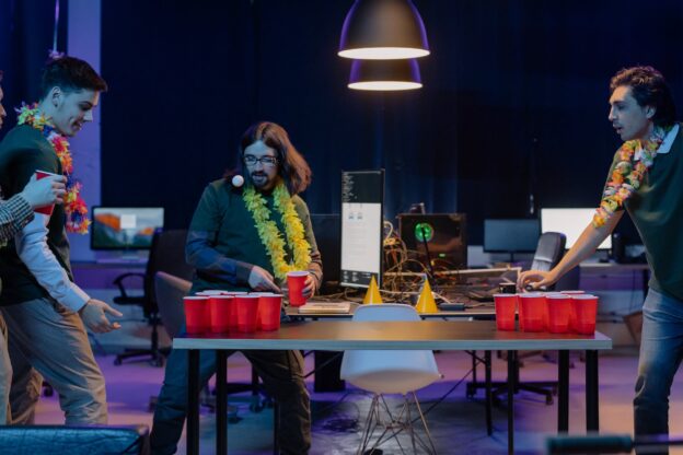 A group of students playing beer pong one of Drinking Games Among WV Students