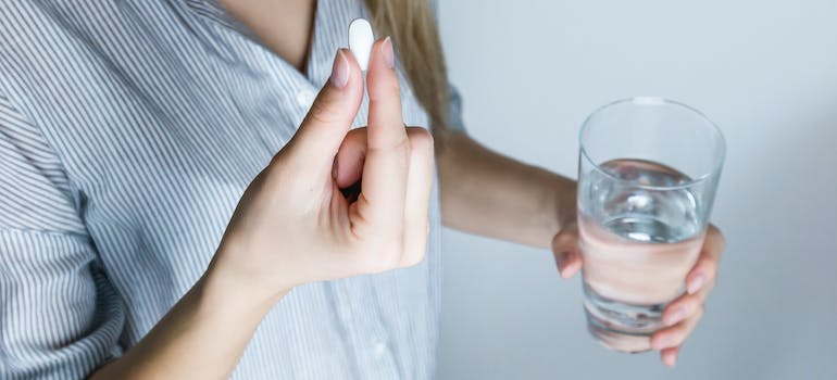 A person taking a pill