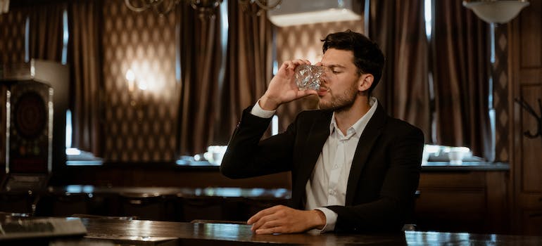 A person drinking alone in a bar