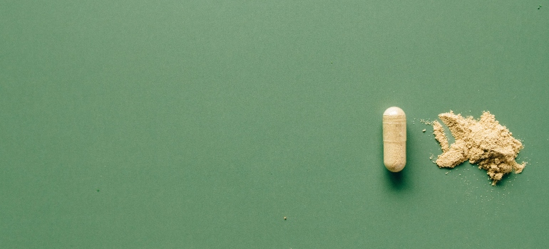 A yellow pill on a green background
