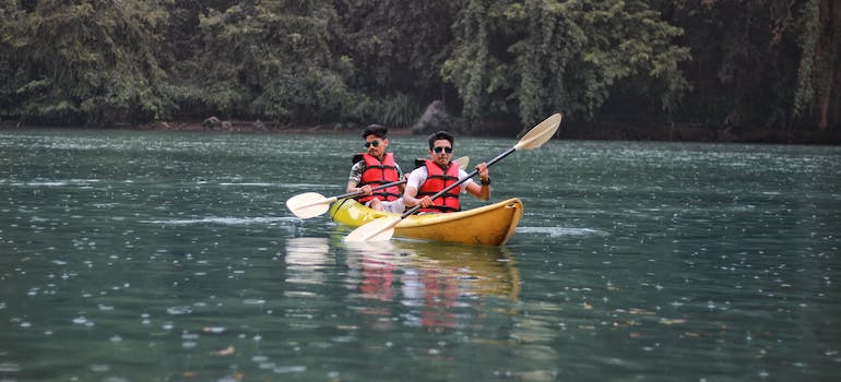 men canoeing on a lake.