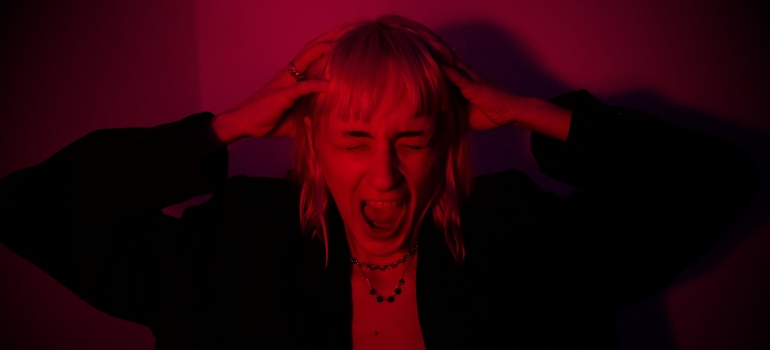 Girl screaming anxiously after taking Tesla pills.