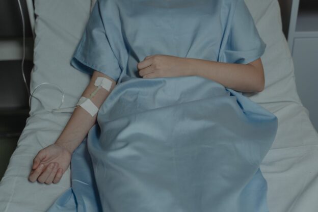 A patient is lying in bed after rapid detox.