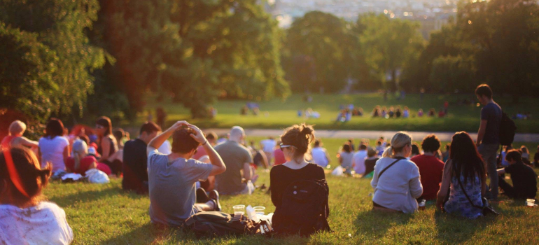 A group of people enjoying a sunny day in the park, showcasing the strength found in community.