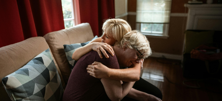 a woman supporting her friend and helping her make a crisis management strategy for long-term recovery in WV