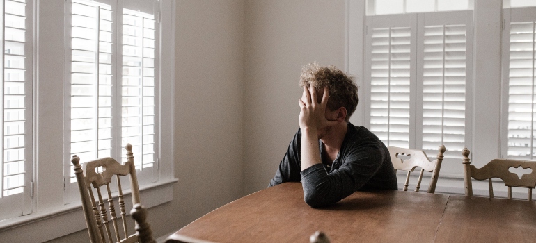 A stressed man sitting at a table