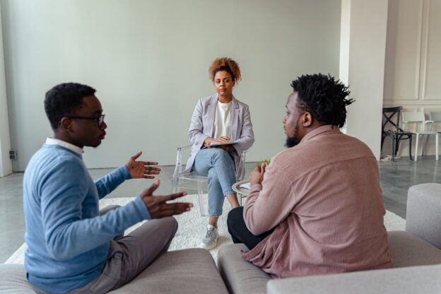 Two men talking to a therapist about living with an alcoholic in WV