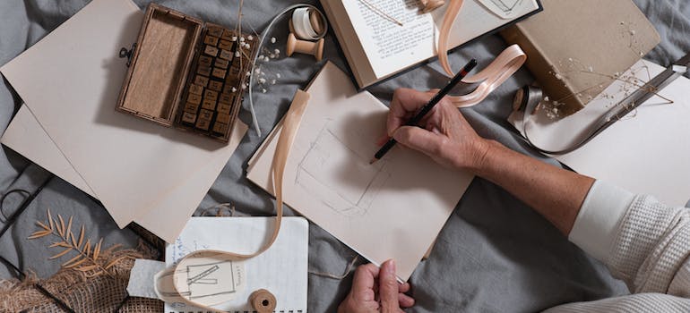 A person sketching while reflecting inner thoughts through art therapy